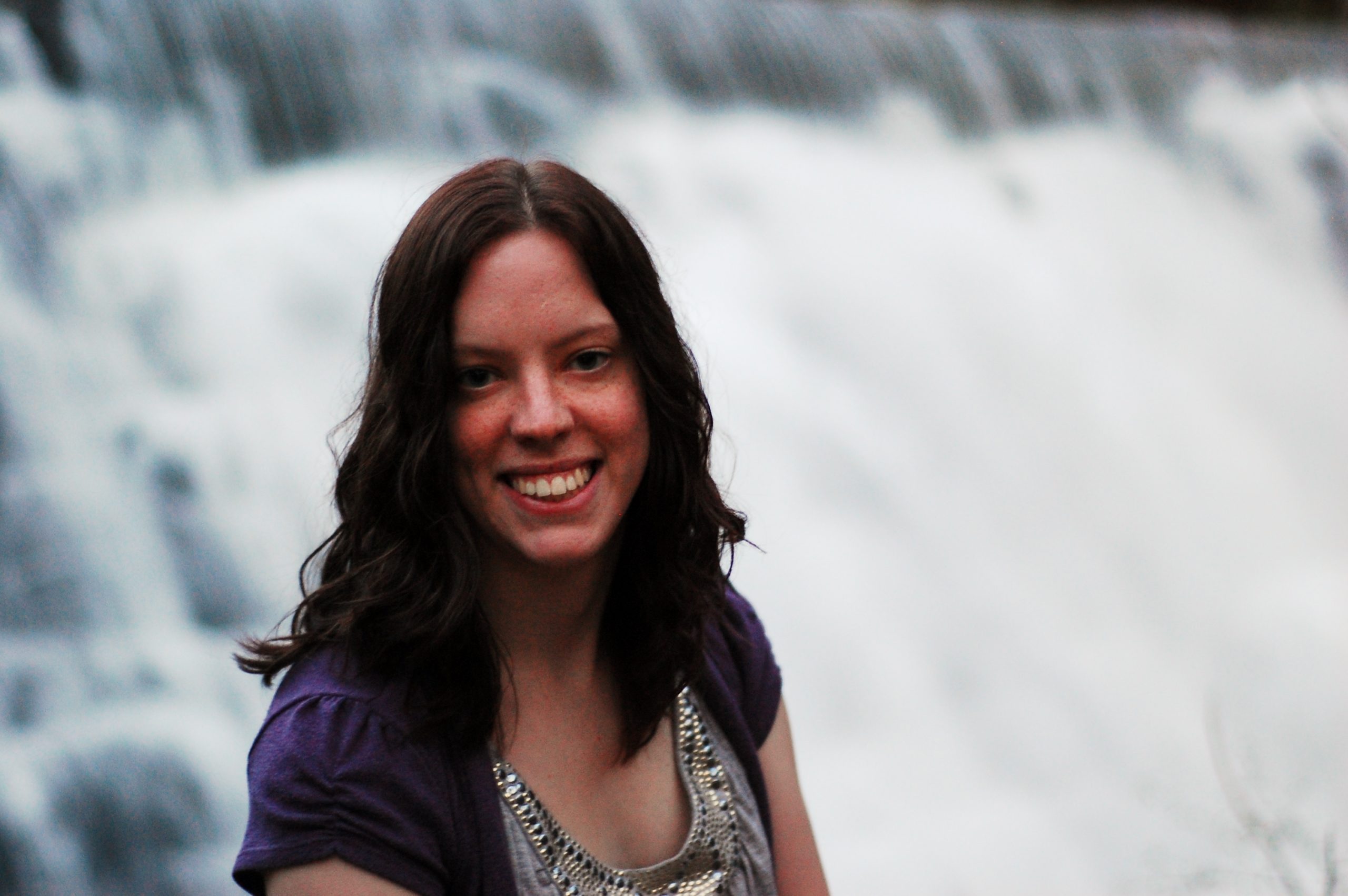 Photo of Amelia Hall in front of a waterfall